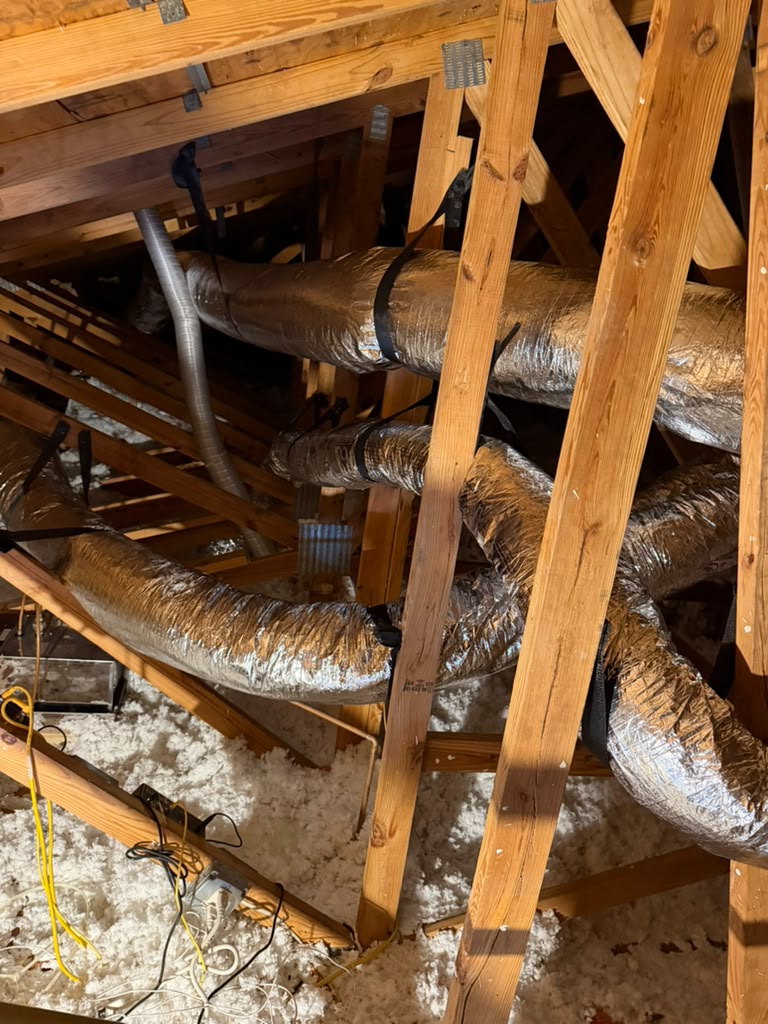 New insulated flexible ductwork strapped between attic rafters