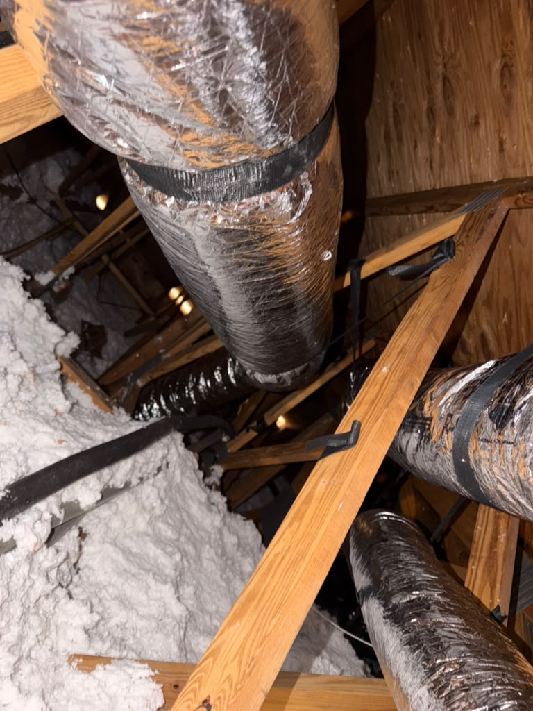 Close view of insulated duct runs in an attic